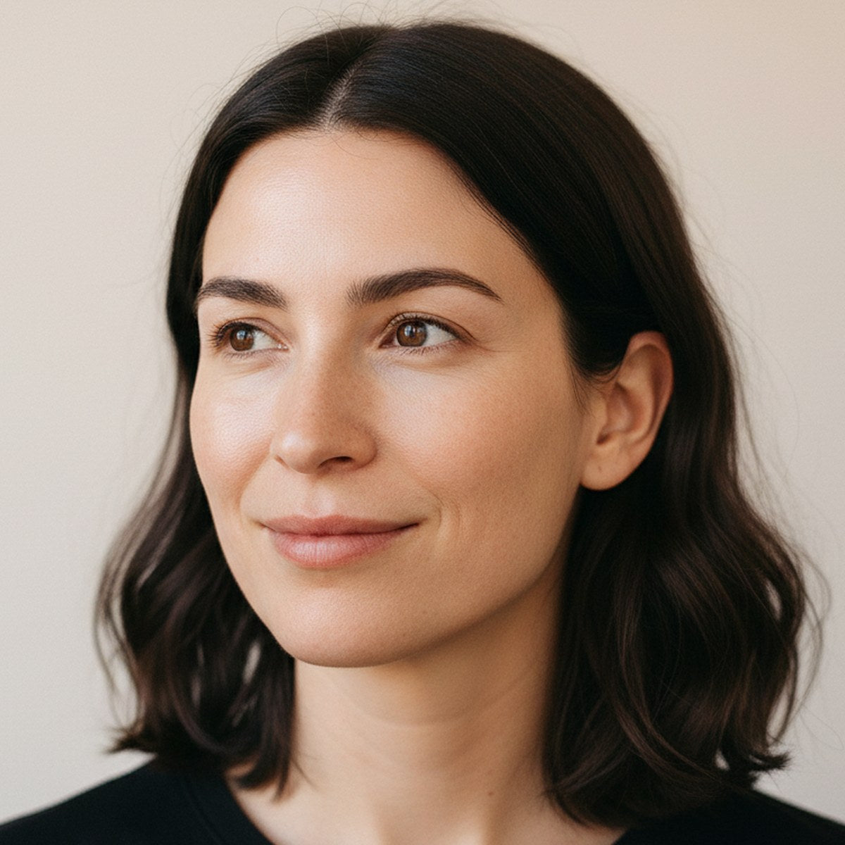 Brightening and dark spots: a woman with bare, freshly cleansed skin in soft daylight