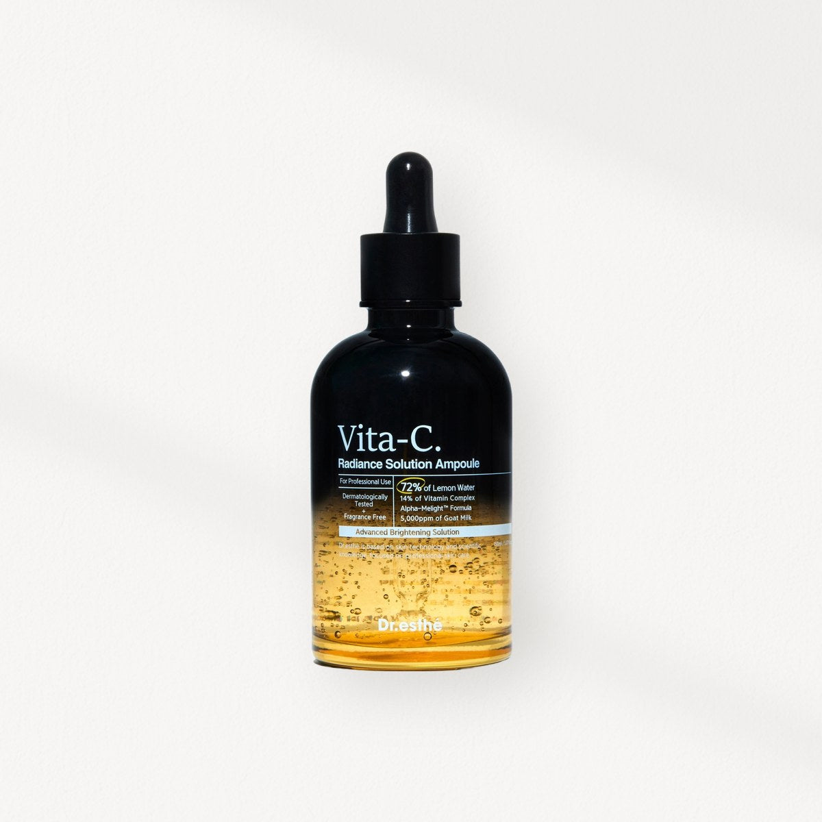 Dr. Esthe: the Vita-C Radiance Solution Ampoule bottle on a warm plaster wall