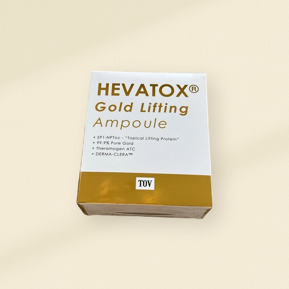 HEVATOX: the HEVATOX Gold Lifting Ampoule carton on a warm plaster wall