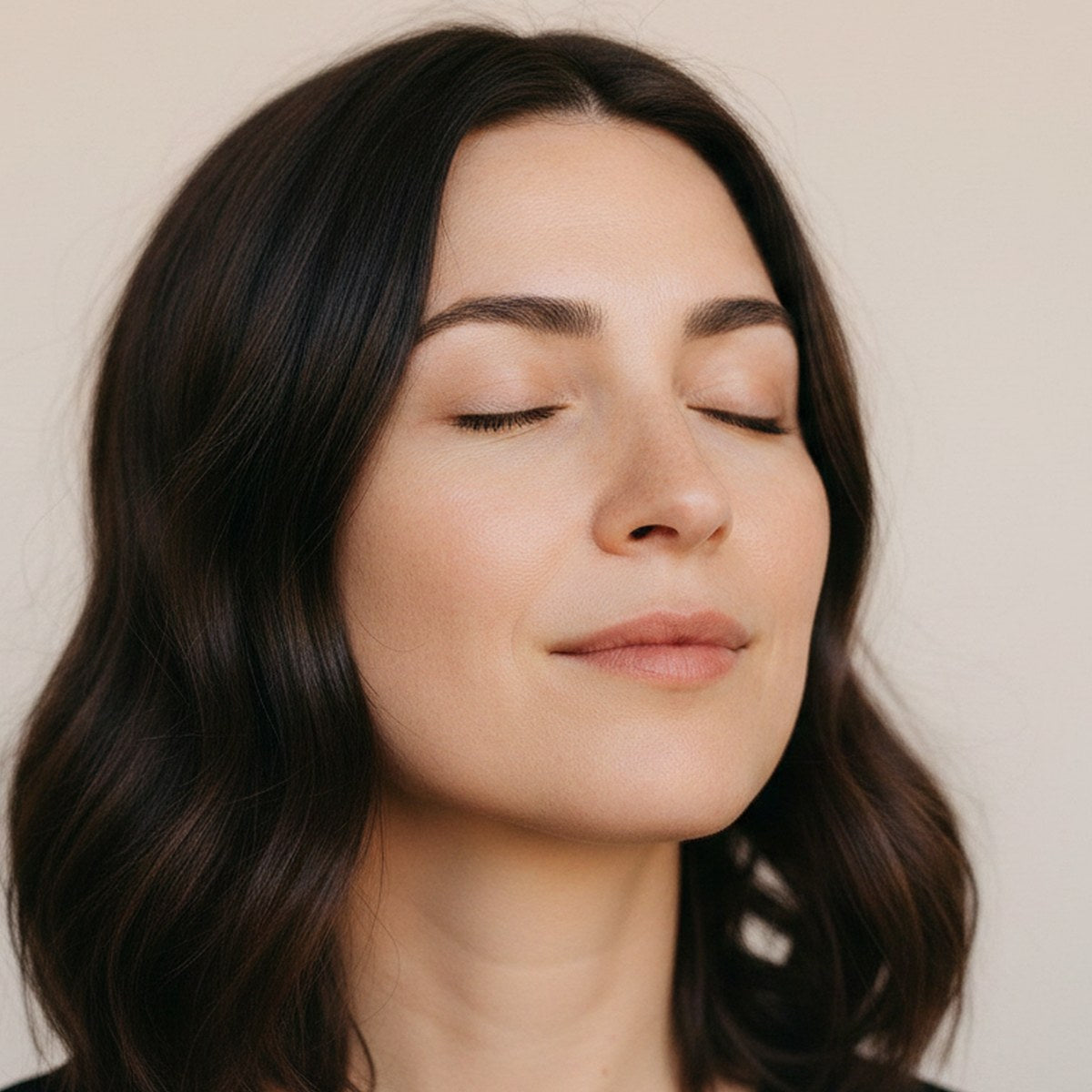 Hydration: a woman with eyes closed and dewy, freshly moisturised skin