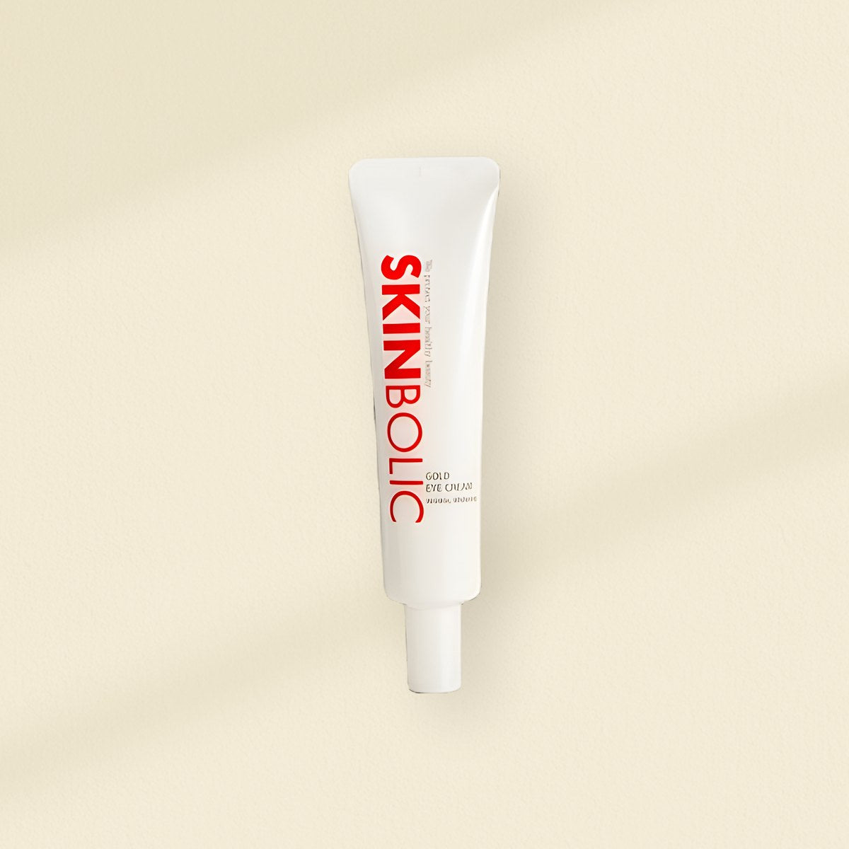 SKINBOLIC: the SKINBOLIC Gold Eye Cream tube on a warm plaster wall