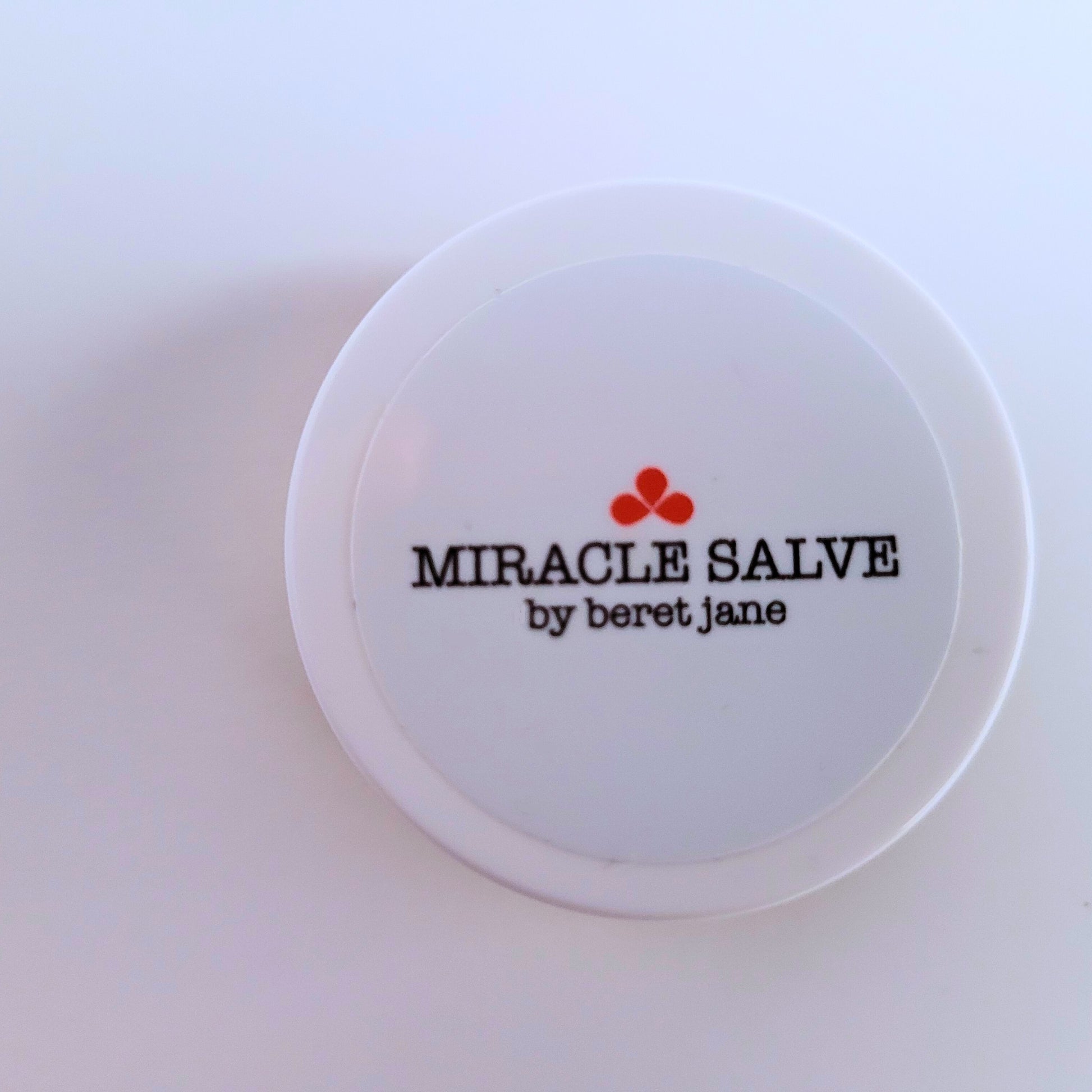 Top view of the Beret Jane Miracle Salve small .1 oz jar